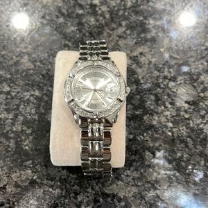 Used Guess watch. Shows signs on wear. Needs a new battery